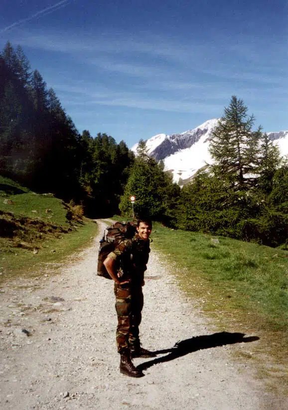 A photo of me when I was in the Army, walking through a path in the Alps.