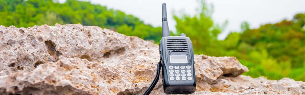Photo of a handheld radio on a rock.