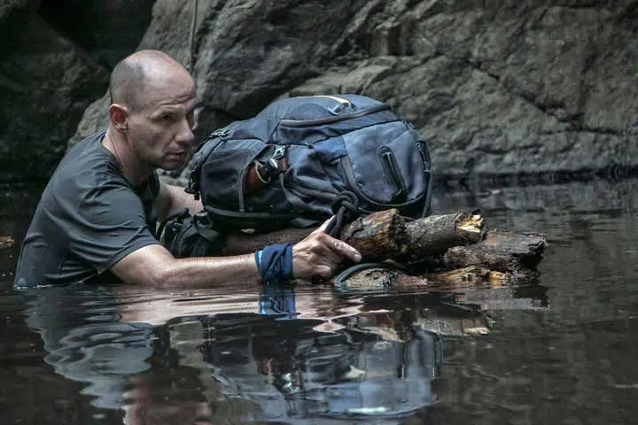 Image of a survivalist crossing water. 