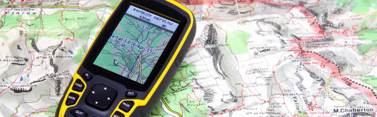 Photo of a Garmin GPS on a map. .