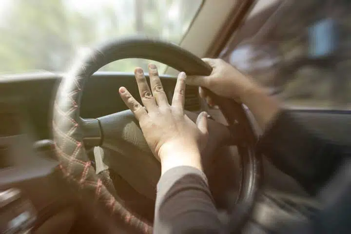 Photo of a driver blowing the horn. 