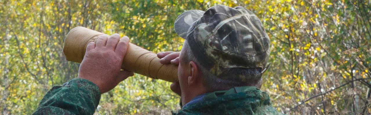 Photo of a hunter calling deer.