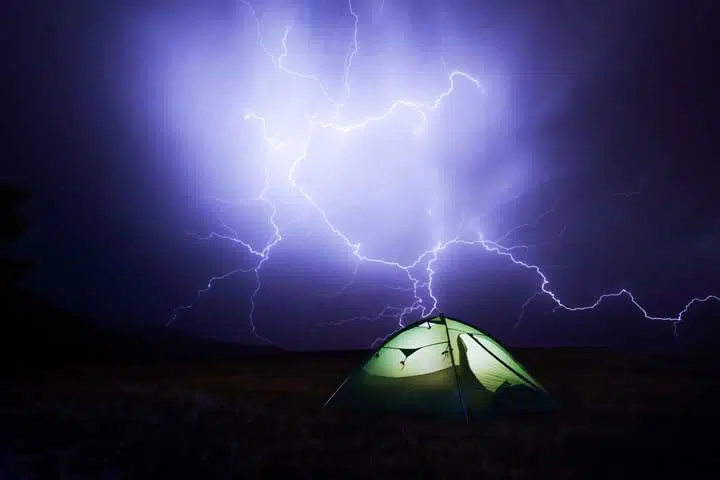 Photo of a tent under a thunderstorm. 