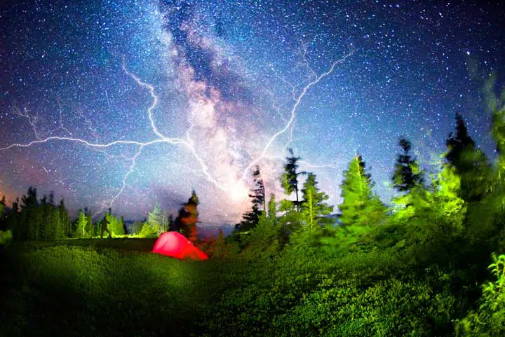 Photo of a tent in the middle of a thunderstorm. 