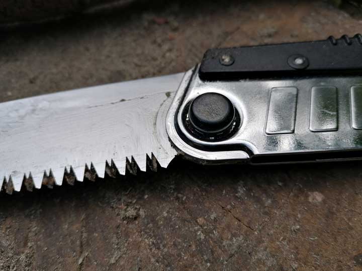 Detail of the folding mechanism of a foldable bushcraft saw. 