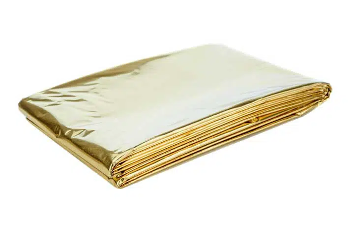 A golden aluminium foil emergency first aid kit heat sheet on a white background. 