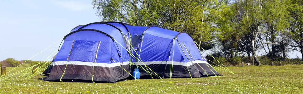 Photo of a 10 person tent in the wilderness.