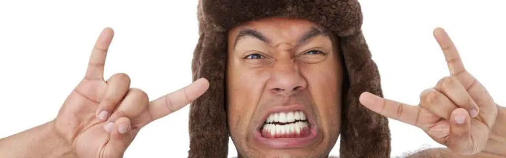 Shirtless Man Wearing a Beaver Hat and Making Sign of the Horns Hand Gestures.