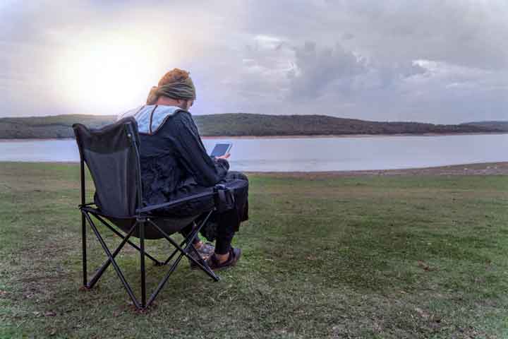 camping,man,nature,sunlight,tablet,camping chair,freedom. 