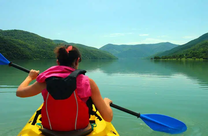 Kayaker rowing on Jinvali lake, Ananuri, Georgia. 