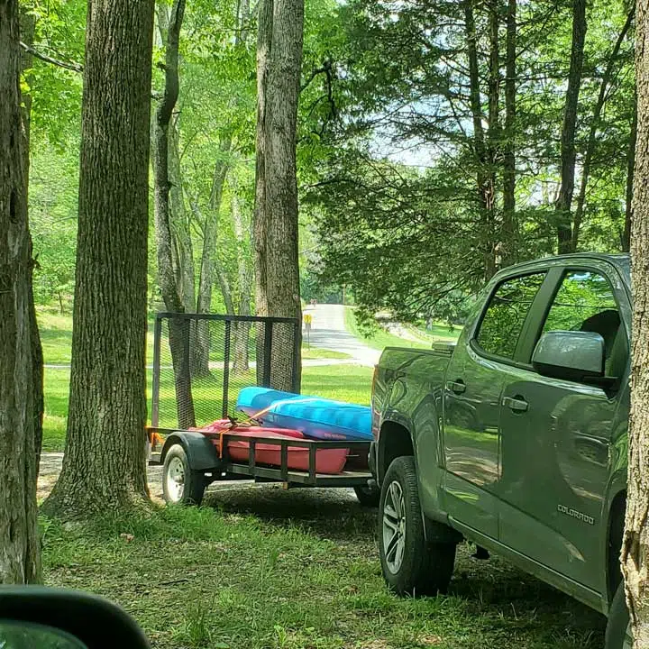 truck trailer with two kayaks. 