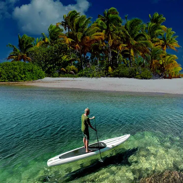 Photo of a kayaker on a beach with the Tower Xplorer 14 SUP Kayak. 