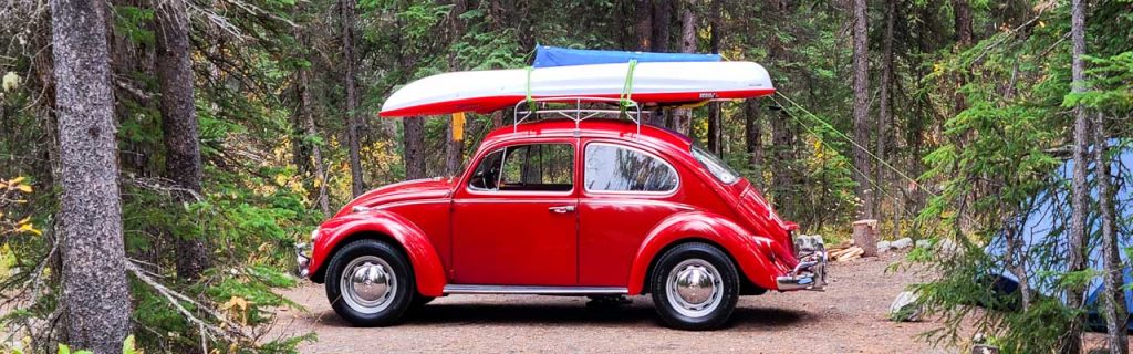 Well maintained camp site equipped with tent and a Kayak on roof rack ready to explore the local Saskatchewan river.