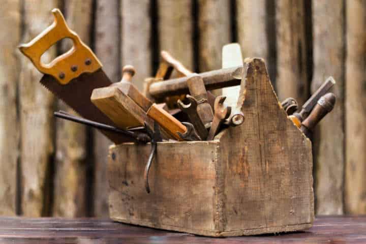 vintage tool box on wooden table, on wood background.