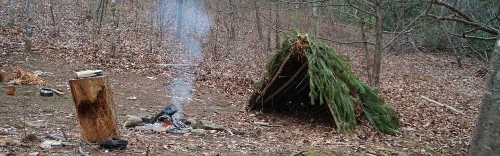 Blanket, shelter, fire in the forest.