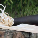 Wooden feather stick and knife in forest prepared for making fire, important when choosing where to learn bushcraft